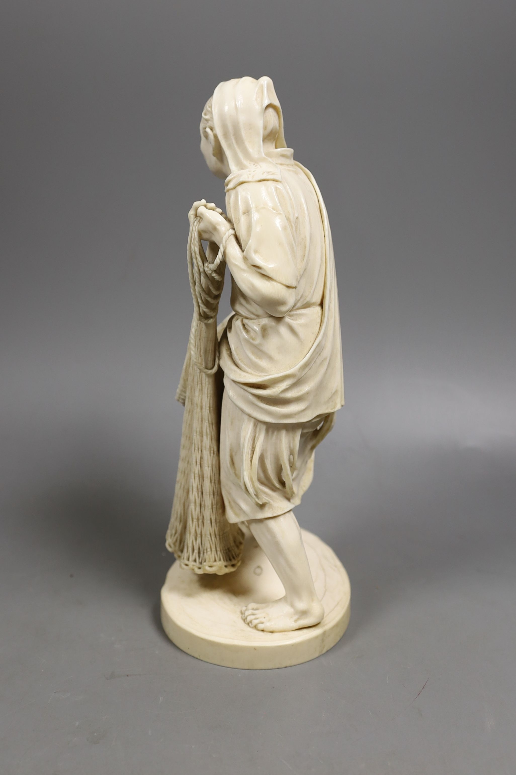 A large Japanese Tokyo School ivory figure of a fisherman, signed, Meiji period, 26 cms high.